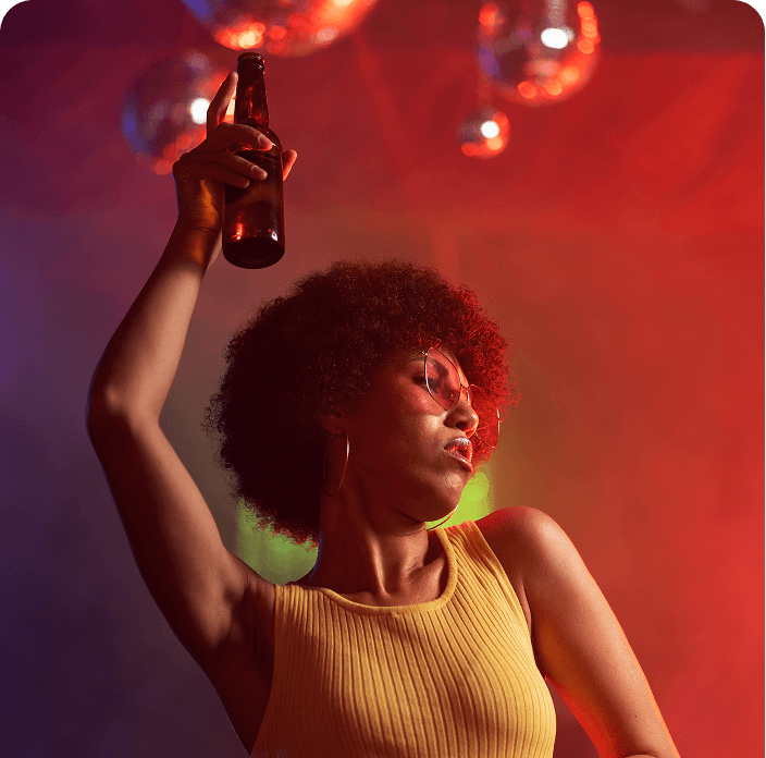 Woman celebrating with a drink raised